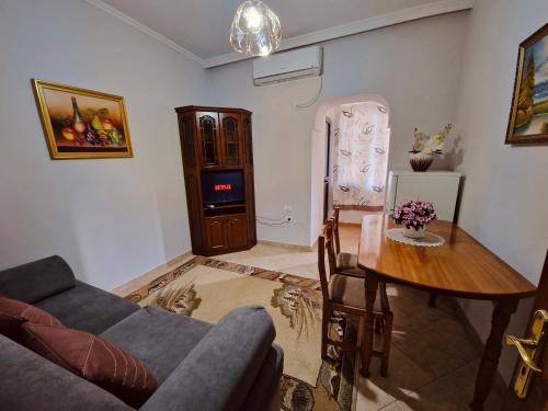 een woonkamer met een bank en een tafel bij Tirana City Center Apartment in Tirana