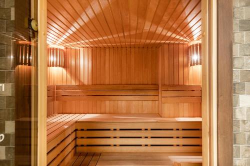 a sauna with wooden walls and a wooden floor at Europa Royale Druskininkai in Druskininkai