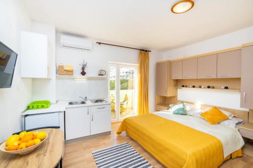 a bedroom with a bed and a bowl of fruit on a table at Apartments by the sea Podaca, Makarska - 9712 in Podaca