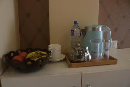 a counter with a coffee maker and a bowl of food at Hotel Family Ties Pvt. Ltd. in Kathmandu