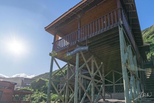a large wooden building with a staircase on it at No10@Kamma in Eersterivierstrand