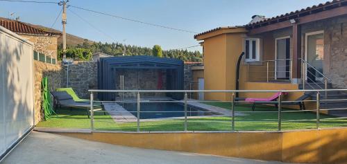 a balcony with two chairs and a swimming pool at Casa Pinto - AL in Valença