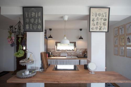 a dining room with a table with a mirror at KalácsHáz Dörgicse in Dörgicse