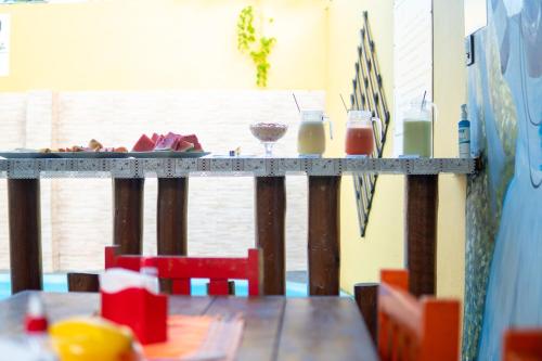 a table with food and drinks on top of it at PV Pousada Passarela da Vila in Itacaré