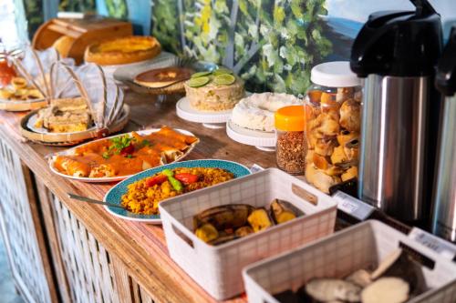 a buffet with many different types of food on a table at PV Pousada Passarela da Vila in Itacaré