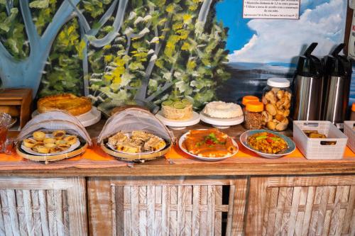 a buffet with different types of food on a table at PV Pousada Passarela da Vila in Itacaré