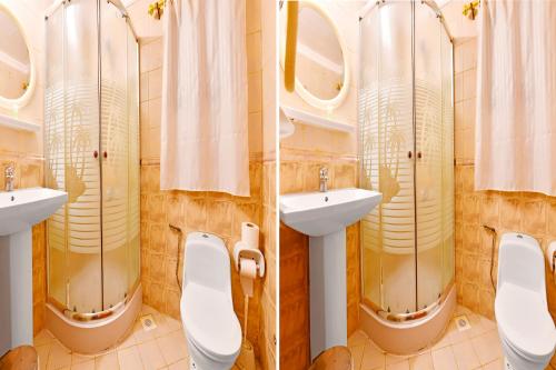 2 vistas para uma casa de banho com 2 lavatórios e espelhos em Capital O 125 Moon Plaza Hotel em Manama