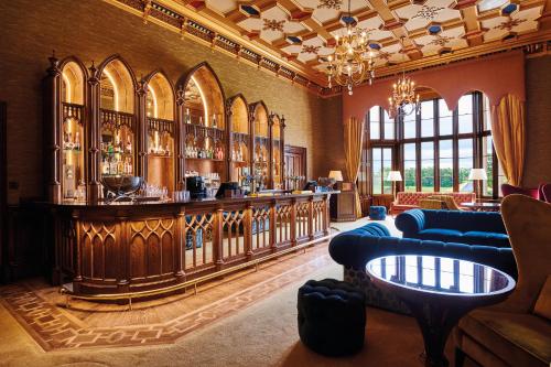 a large room with a bar in a building at Matfen Hall Hotel, Golf & Spa in Matfen