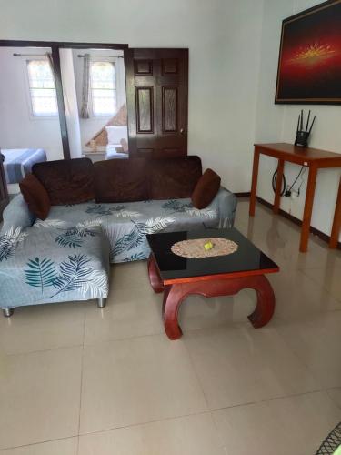 a living room with a couch and a table at Wirason villa 2BR in Koh Samui 
