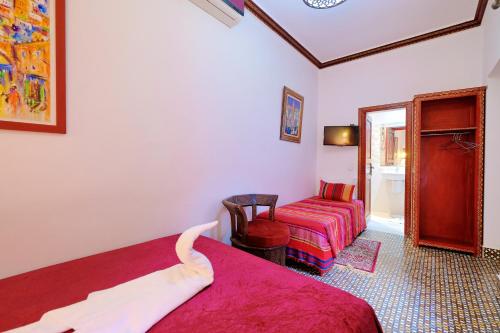 Ένα ή περισσότερα κρεβάτια σε δωμάτιο στο Riad Hôtel Essaouira