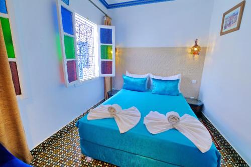 Ένα ή περισσότερα κρεβάτια σε δωμάτιο στο Riad Hôtel Essaouira
