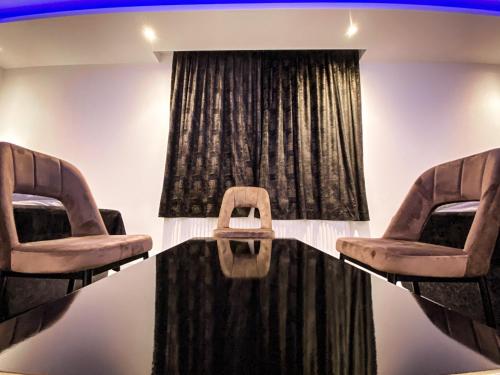 a room with two chairs in front of a window at NRing Villa am Nürburgring in Adenau