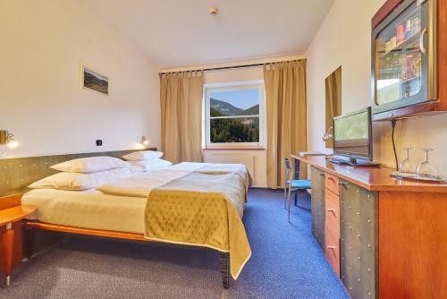 מיטה או מיטות בחדר ב-Hotel Horizont