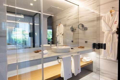 a bathroom with a sink and a glass shower at Pınar Otel in Erdek