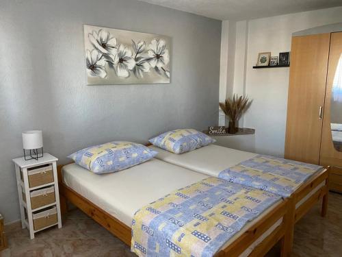 a bedroom with a bed and a painting on the wall at Apartments with parking space Sutivan, Brac - 2846 in Sutivan