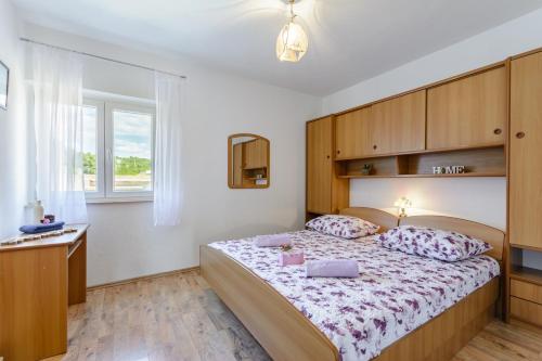 a bedroom with a large bed with a wooden headboard at Apartments by the sea Sumartin, Brac - 2952 in Sumartin