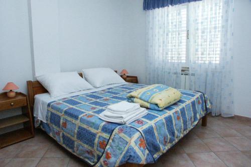 a bedroom with a bed with towels on it at Apartments and rooms with WiFi Vrsar, Porec - 3007 in Vrsar