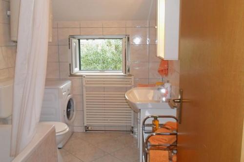 a bathroom with a sink and a toilet and a window at Apartments and rooms with parking space Bol, Brac - 2926 in Bol