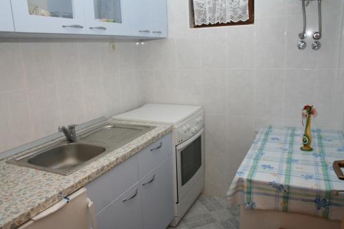 een kleine keuken met een wastafel en een fornuis bij Double Room Sutivan 2943b in Sutivan