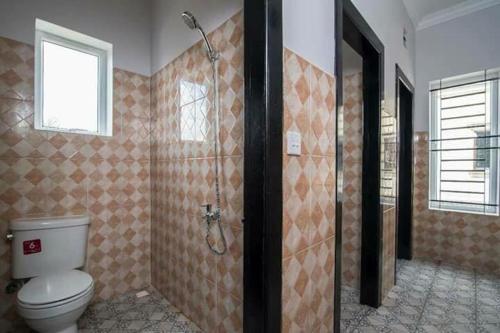 a bathroom with a toilet and a shower at AGOGO Hostel in Siem Reap