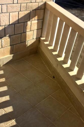 a brick wall with a staircase next to a brick floor at Apartments by the sea Sumartin, Brac - 2951 in Sumartin