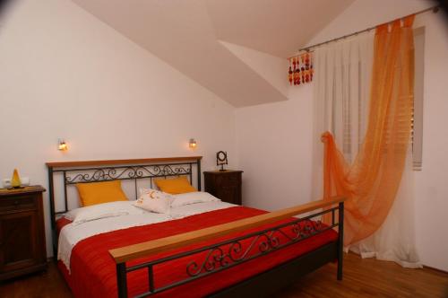 a bedroom with a large bed with a red blanket at Apartments with a parking space Bol, Brac - 2900 in Bol