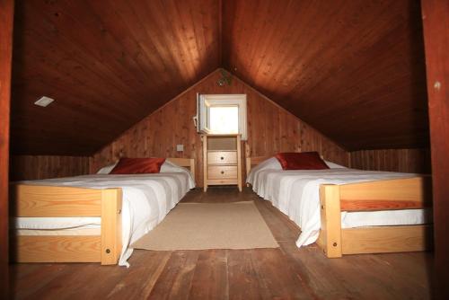 a bedroom with two beds in a wooden cabin at Holiday house with a parking space Bol - Brac - 2894 in Bol