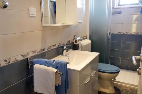 a bathroom with a sink and a toilet and a mirror at Apartments with a parking space Bol, Brac - 2890 in Bol