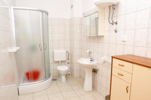 een badkamer met een douche, een toilet en een wastafel bij Apartments by the sea Sumpetar, Omis - 2965 in Jesenice