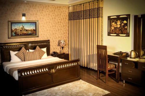 Voodi või voodid majutusasutuse Royal Elegance Hotel toas
