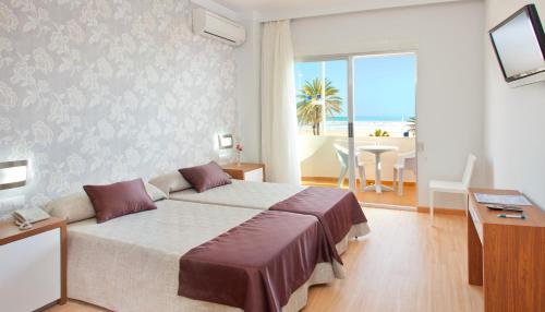 a bedroom with a bed and a view of the ocean at Hotel RH Riviera - Adults Only in Gandía