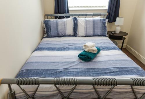 a bed with a hat on top of it at Resource Homes in Bradshaw