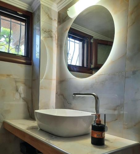 a bathroom with a sink and a mirror at House with View in Agia Paraskevi
