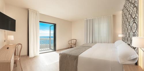 a hotel room with a bed and a large window at Gastrohotel Boutique RH Canfali in Benidorm