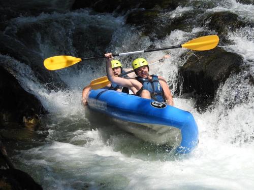 a man and woman in a raft in a river at Holiday House Provance in Brod na Kupi
