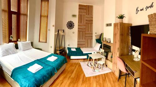 a bedroom with a bed and a desk and a television at Two Bedroom Apartment -Welcome to Burgas- Top Location, Central Station, Main Walking Street, Sea Garden, near the Beach in Burgas