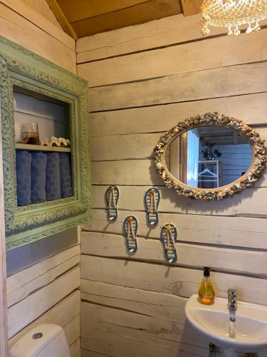 a bathroom with a mirror and a sink at Milleri in Salacgrīva