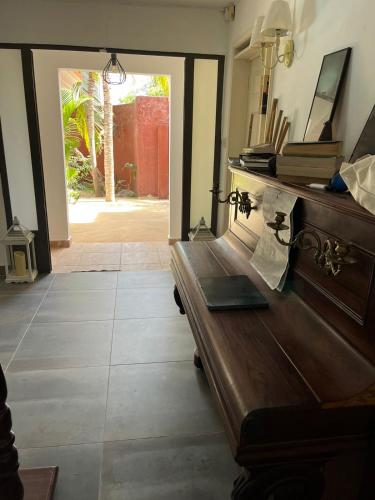 a wooden bench in a room with an open door at Villa Tourelle of Paradise with bigPrivate Pool in Rivière Noire
