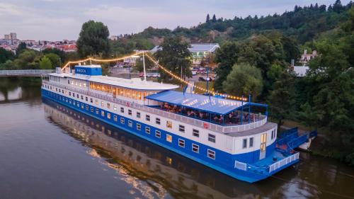 a cruise ship on the river at night at Botel Racek in Prague
