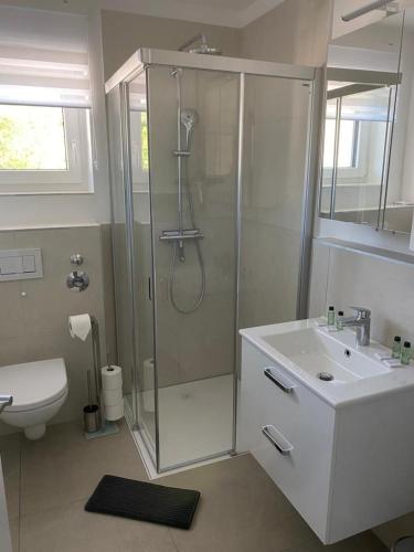 a bathroom with a shower and a sink at Quality See Apartments Reifnitz in Reifnitz