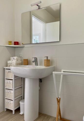 a bathroom with a white sink and a mirror at Casa Doris in Oggebbio