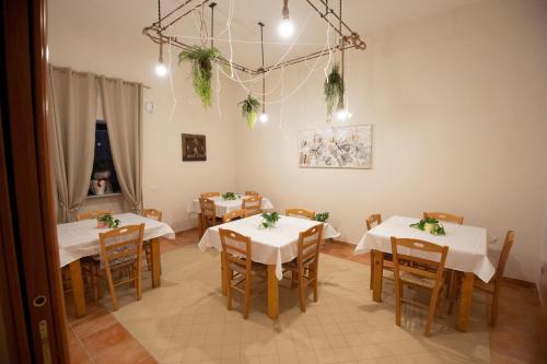 a dining room with tables and chairs with white tablecloths at DONNA ROSITA in San Felice a Cancello