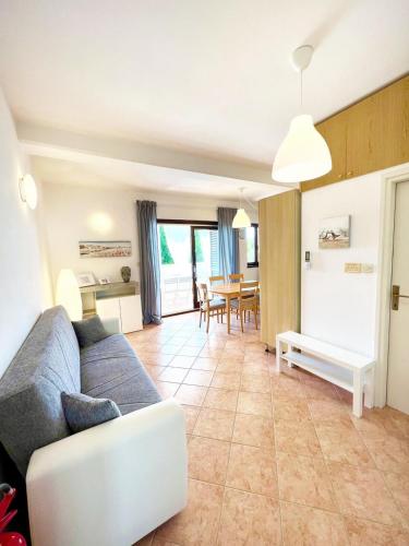 a living room with a couch and a table at Villa Ortensie Apartments in Funtana