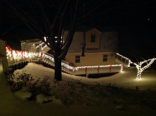 a house decorated with christmas lights in a yard at Trickling Waters Retreat in Marquette
