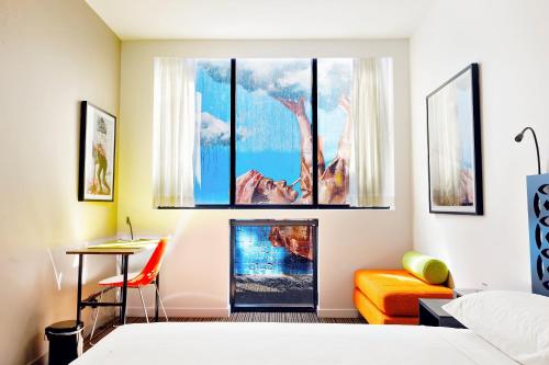 a bedroom with a bed and a painting on the wall at The Constance Fortitude Valley in Brisbane