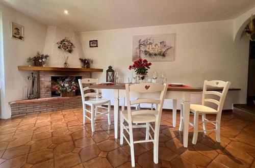 a dining room with a table and chairs and a fireplace at Il Bosco e Il Borgo Guest House Subiaco in Subiaco