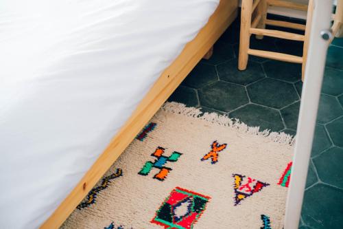 a floor rug with legos on it in a bedroom at Manzili Surfhouse in Tamraght Ouzdar