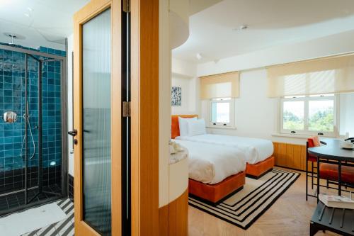 a hotel room with a bed and a bathroom at The Gift Hotel in Istanbul