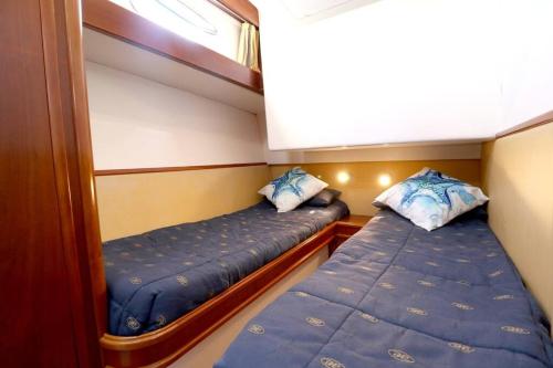 two beds in a small room on a boat at Private yacht, we love our guests in Lisbon