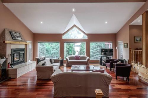 a living room filled with furniture and a fireplace at Le Chaleureux du Lac Blanc - Nominingue in Nominingue